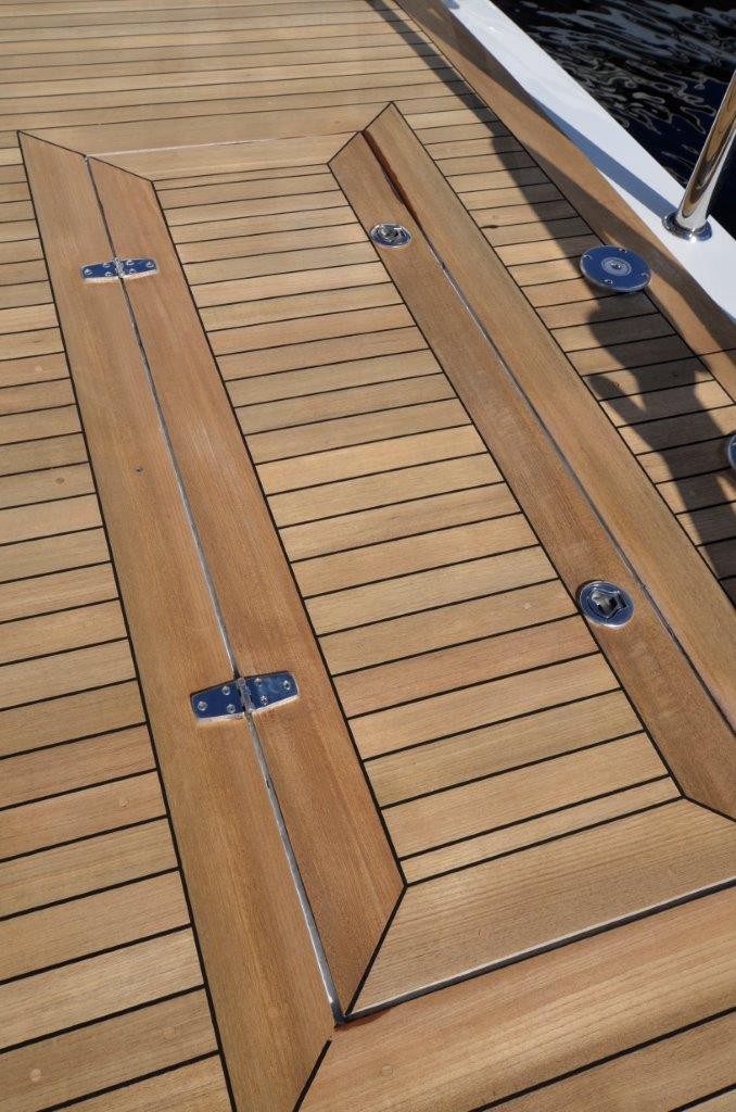 Wooden boat deck with hatch and hinges.