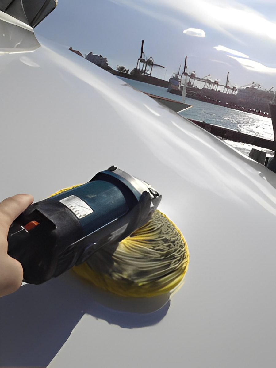 Polishing a boat near a harbor.