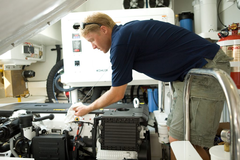 Man inspecting engine in a workshop.