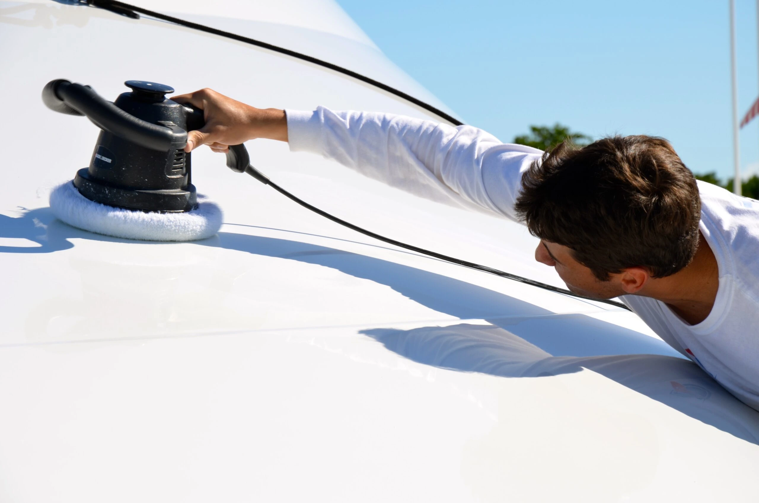 A man providing luxury yacht detailing at Pier Sixty-Six Fort Lauderdale.