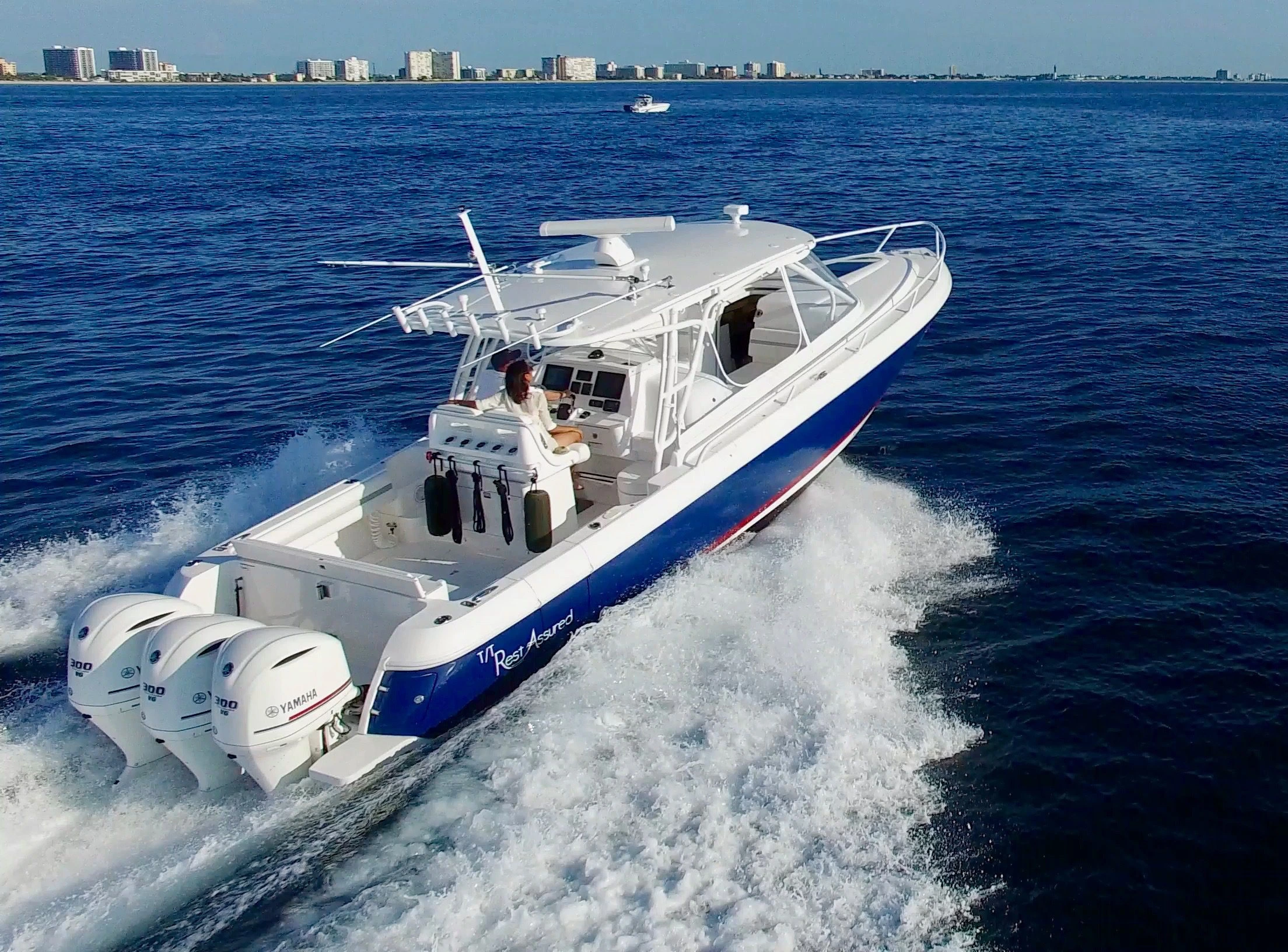 A man and woman riding a yacht with detailing.