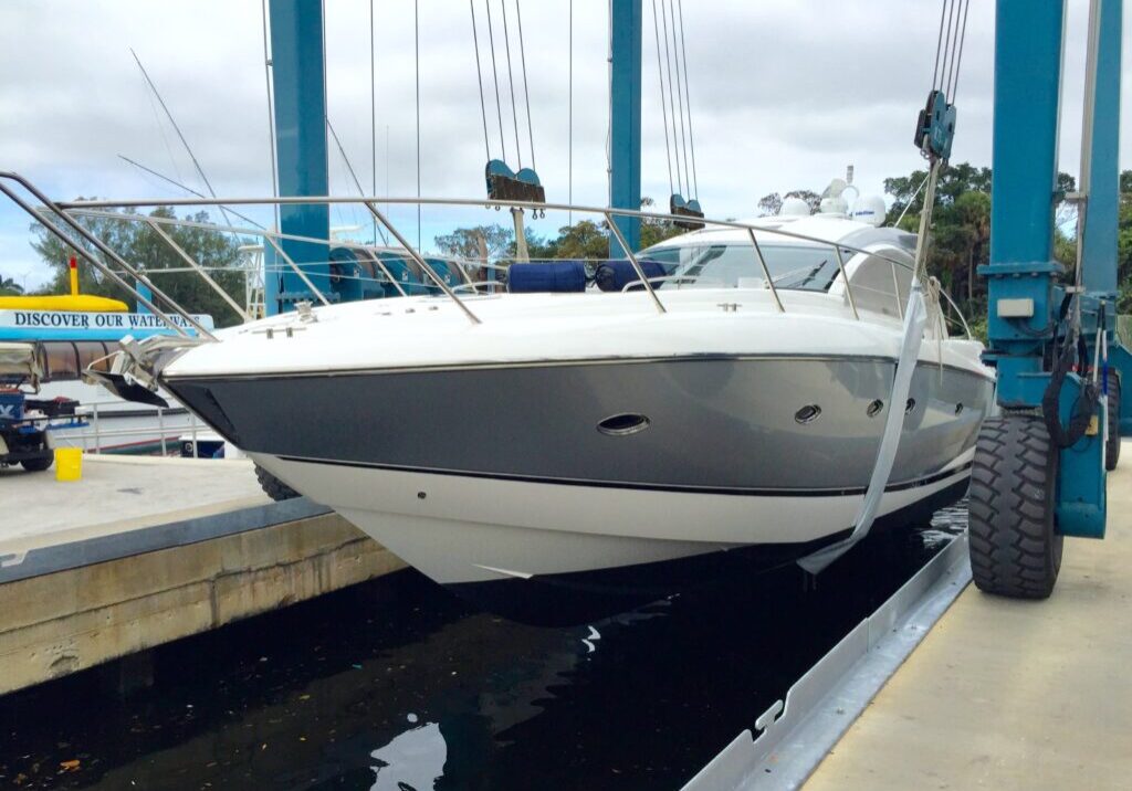Boat being lifted in a shipyard.